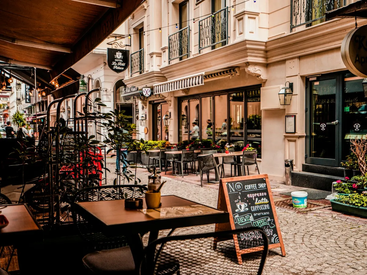 The café's street-side tables and chalkboard menu