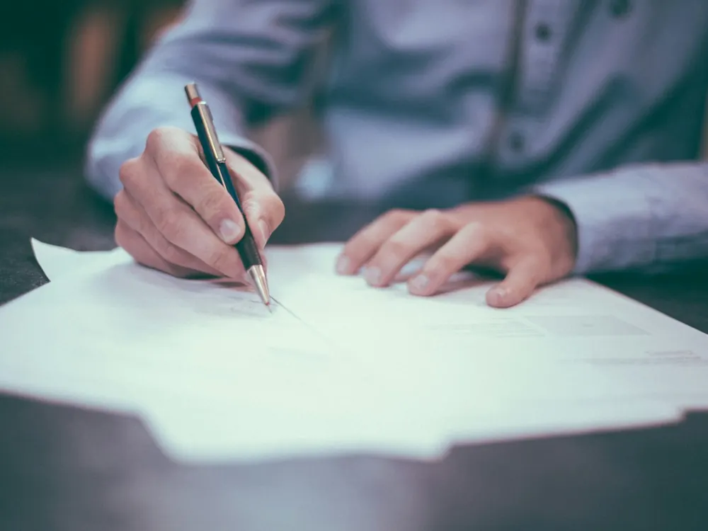 Signing an agreement at a desk
